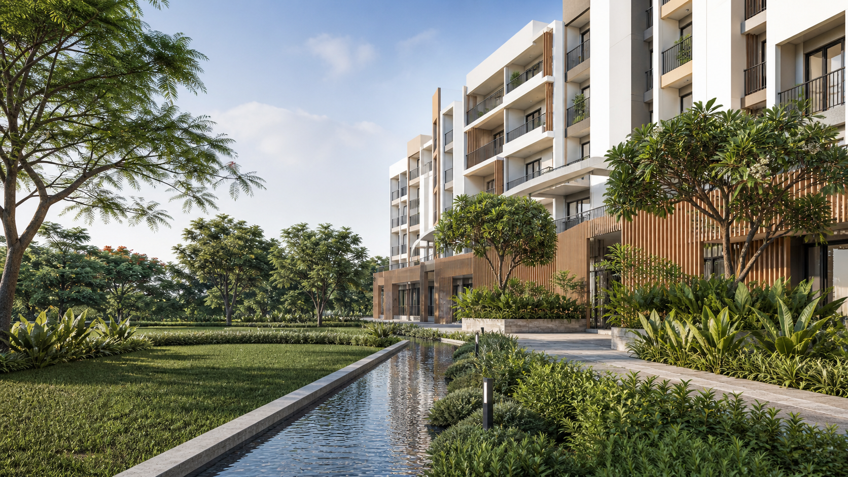 Urbanrise The Living Wave apartments beside a landscaped lawn and water rill in Gattahalli