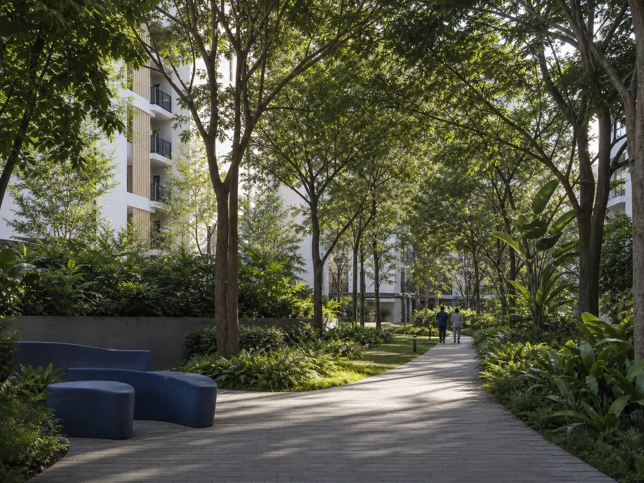 Curving shaded garden walk beneath a dense tree canopy with apartment buildings beyond