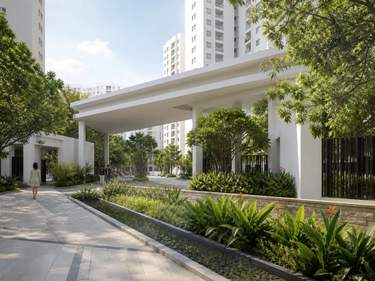 White residential arrival canopy beside tropical planting and a shallow rain-garden edge